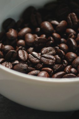close up of coffee beans in a white bowl