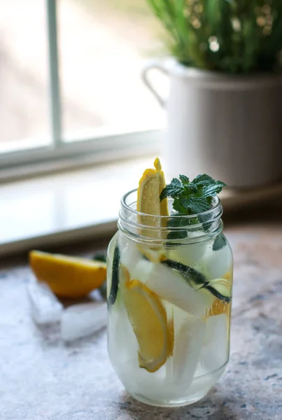 Glass Jar Water Lemon Cucumber Mint Marble Table Blurred Background — стоковое фото
