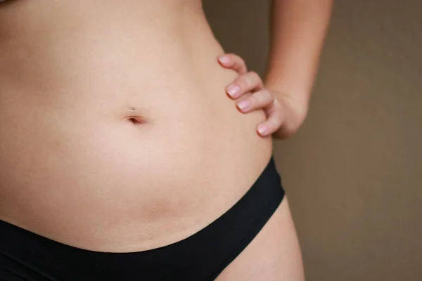 close up of postpartum belly, confidence body