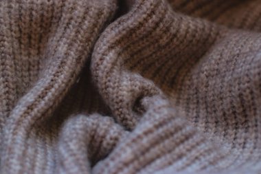 close up of a brown beige knitting fabric, texture background