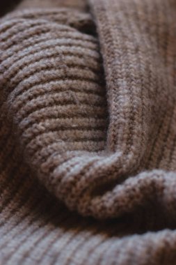 close up of a brown beige knitting fabric, texture background