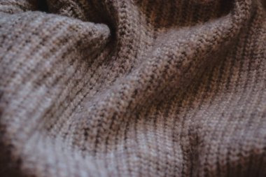 close up of a brown beige knitting fabric, texture background