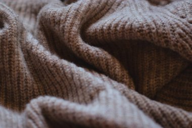 close up of a brown beige knitting fabric, texture background