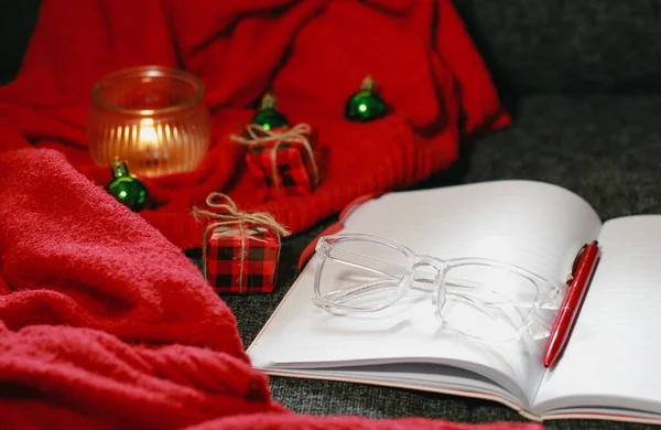 Christmas composition with notebook, pen, glasses, candle and decor. High quality photo