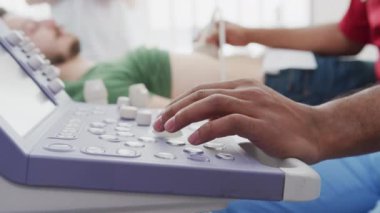 Doctor using a medical ultrasound scanner for an abdominal examination.