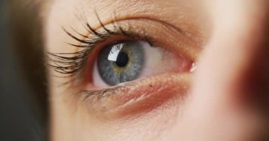 Close up view of a woman's blue eye.