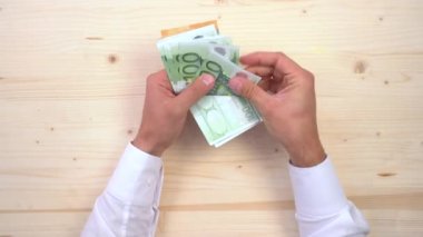 A man Counting euro banknotes