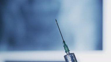 Droplets falling from a syringe needle.