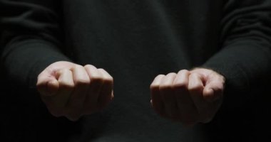 Hand opening to reveal a red and a blue pill.
