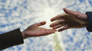 A couple holding hands in front of shiny background