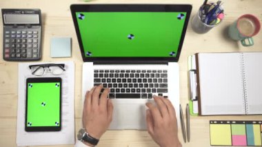 Hands typing on a MacBook at work