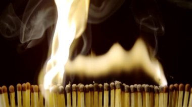 Extreme close up of igniting matches one after another