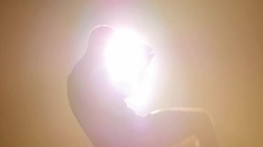 Spotlight on a man kicking