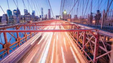Timelapse of cars driving on Brooklyn Bridge at dusk
