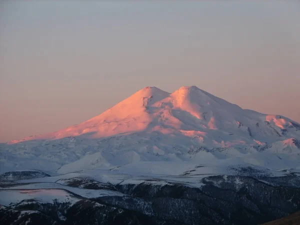 Elbrus is a high mountain. Dormant volcano. mountain covered with snow on blue sky background. Caucasus mountains, slopes