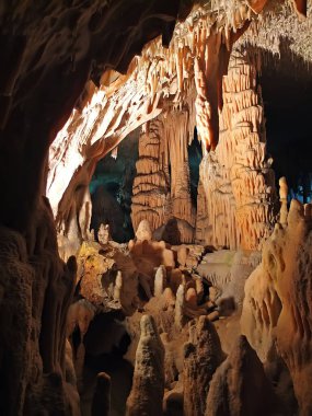 Salactites and stalagmites in the cave. Lighting. Postojna Cave, Slovenia