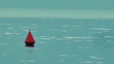 Buoy on the water surface. Sea buoy. Calm water on a lake or river. Background video