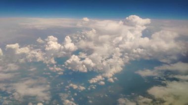 Flying above the clouds. Airplane flight. View from the airplane window. Traveling by air. Cumulus clouds