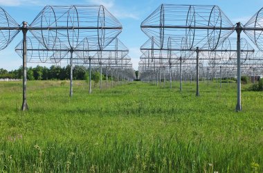 Radio antennas on a field with green grass. Radio telescope UTR-2. Technology and Research