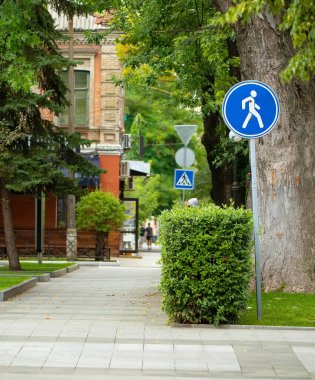 Pedestrian zone sign in the summer park. Pavement in city park. Soft selective focus
