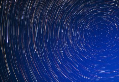 Stars move around the pole star at night. Long exposure