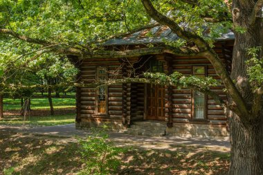 Old log house in the forest on a sunny day. Ivano-Frankivsk city in Ukraine