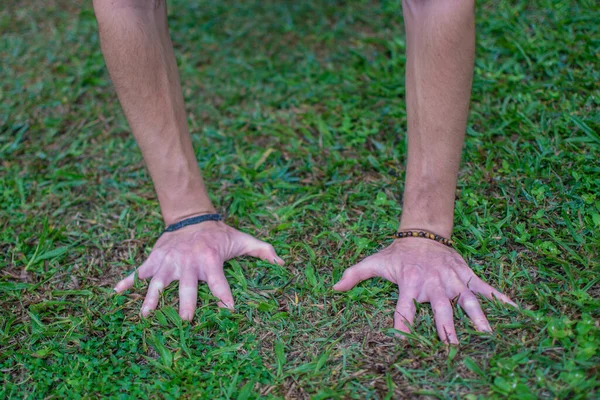 Hands Resting Wet Grass Connecting Ground Horizon — Stockfoto