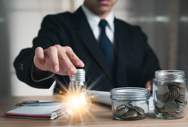 Business Man Holding Light Bulb Taking Notes Jar Coins Concept — Stok fotoğraf