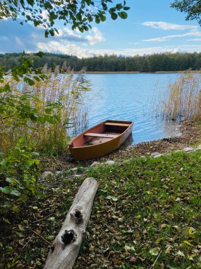boat on the shore of the autumn lake