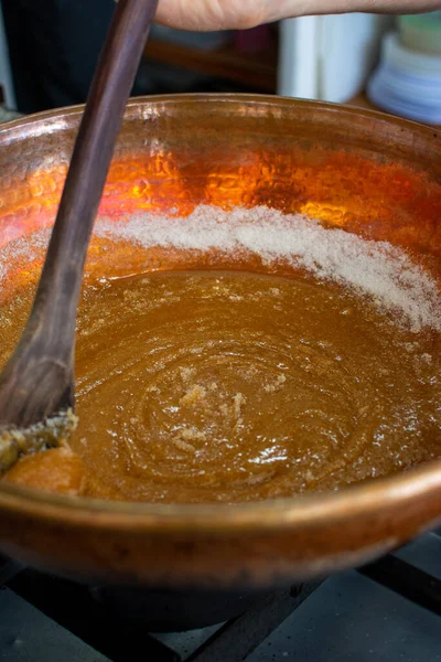 Preparing a macadamias and toffee cake. Kneading, spreading the dough. Toffee preparation. Pastry and pastry.