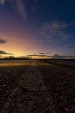 asphalt road at sunrise. long shadows. highway.