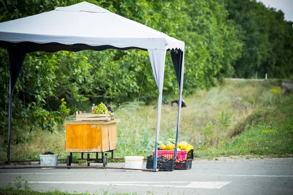 Farmers sell their products on the side of the road