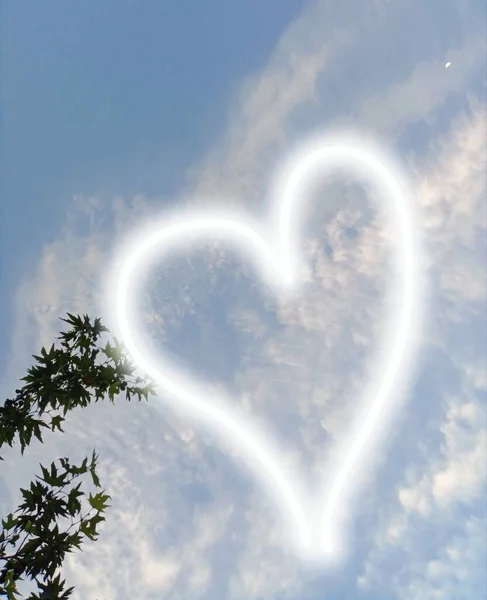 White heart shape in the sky. Wonderful clouds and very beautiful sky. Romantic. Magical. Also nice small moon.