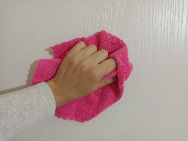 White Door Being Wiped Pink Duster Closeup — Zdjęcie stockowe