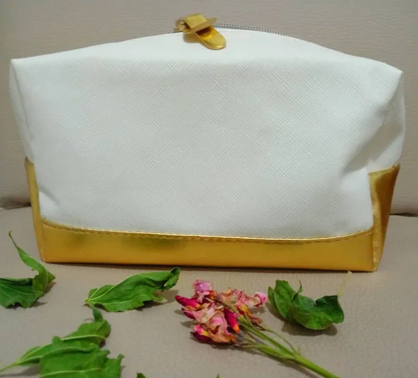 Makeup bag with gold-coloured base and edges.