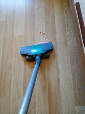 Vacuum cleaner cleaning the floor.