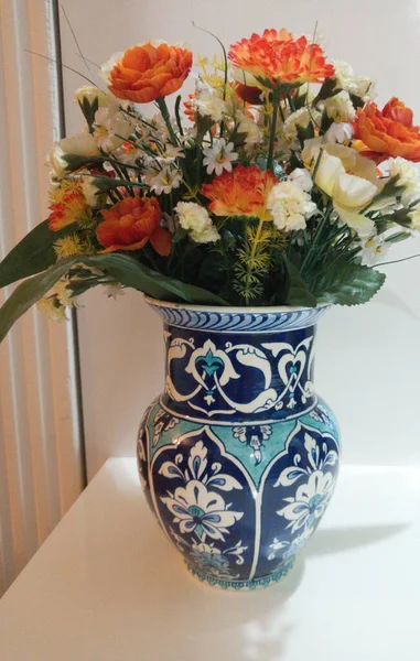 Artificial flowers in a blue vase. Blue vase made in Kutahya. Turkey. Handmade. Traditional vase.