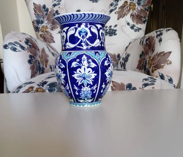 Handmade vase on the table in front of the single sofa. Blue vase made in Kutahya/Turkey. Traditional famous vase.