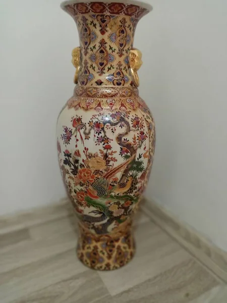 Chinese vase with a dragon pattern. Made in China. Background is blurred.