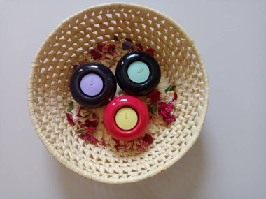 Candles and rose petals in the basket. Decoration idea.