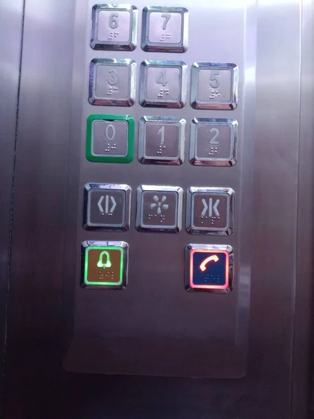 Elevator buttons. The numbers and symbols above the buttons are also for blind people.