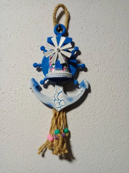 Windmill beaded wall decoration. Blue, white and colorful beads. Beautiful wall decoration.