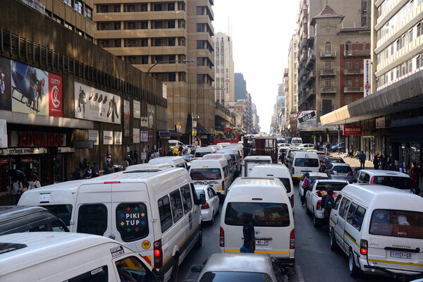 A chaotic downtown scene in Johannesburg, South Africa. So many minibus taxis - the principle mode of transport for millions of the city's inhabitants.
