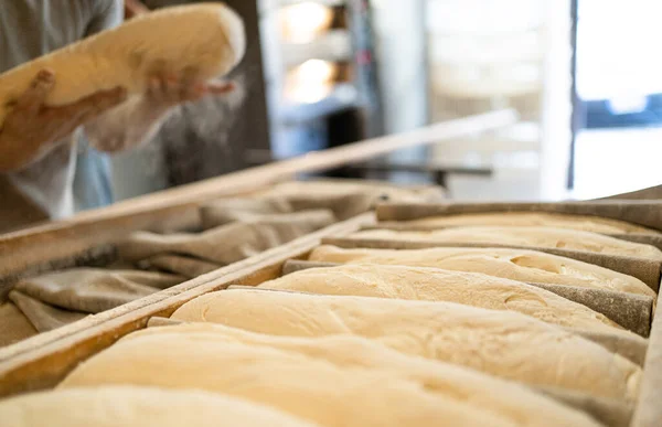 Bakers bring leavened bread to the oven early in the morning, traditional bakery