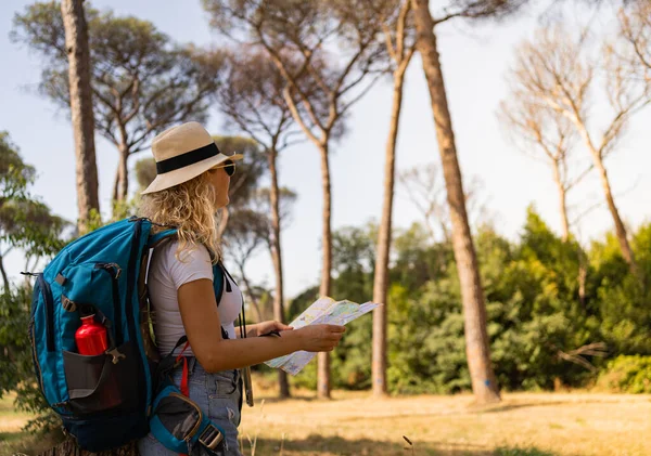 Brave woman explores with her map in the middle of the savannah