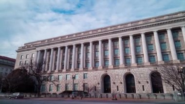 The IRS Building, headquarters of the Internal Revenue Service, in Washington, D.C. seen from Constitution Avenue NW during a winter day in a time-lapse. The wide-angle camera view pans from left to right.