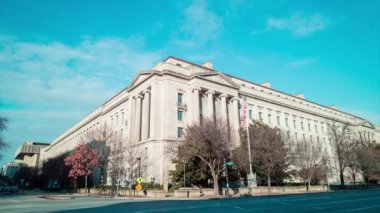 The United States Department of Justice Robert F. Kennedy Building is seen on a winter day from Constitution Avenue NW in downtown Washington, DC. The time-lapse wide shot pans from left to right.