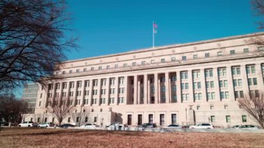 A daytime time-lapse of the Stewart Lee Udall Department of the Interior Building in Washington, D.C. on a sunny winter day. The camera pans from left to right.