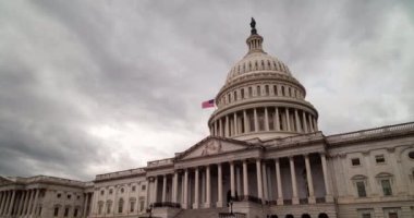 A daytime time-lapse of clouds passing over the east side of the United States Capitol Building in Washington, DC. The camera pans from left to right.