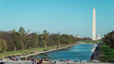 Tourists flock to the Lincoln Memorial Reflecting Pool in this time-lapse. The Washington Monument and U.S. Capitol Dome are seen in the distance.